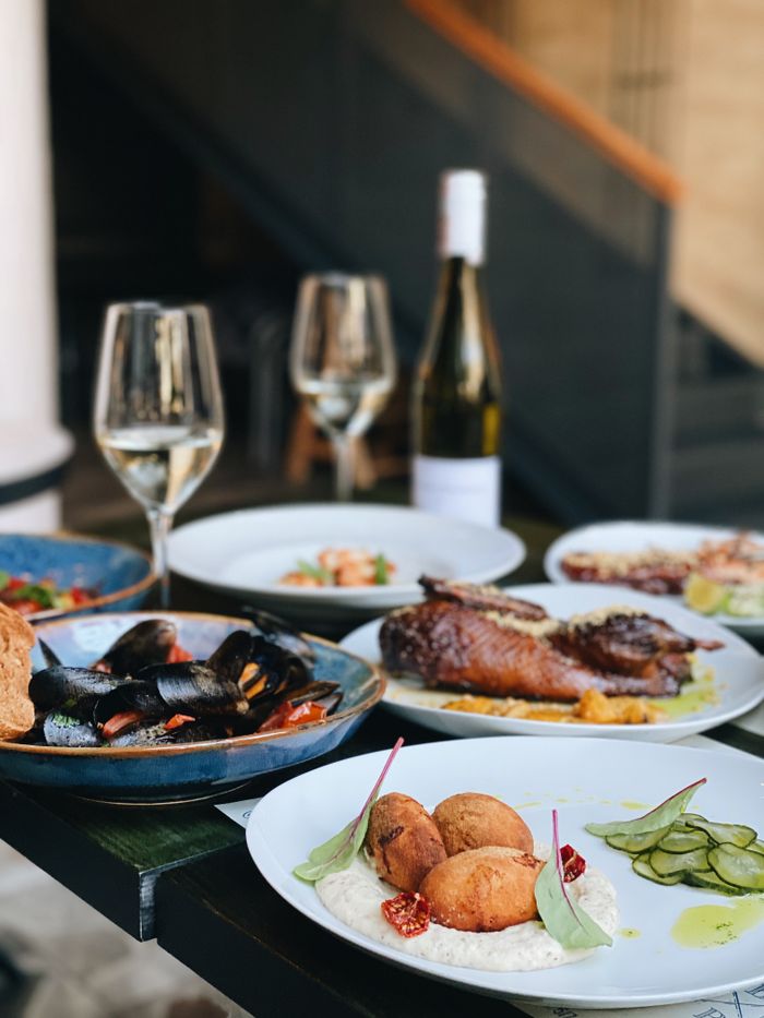 An indulgent display of gourmet dishes paired with fine wine, perfect for dining experiences.